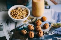 Kaboompics - Walnuts with a fresh healthy shake and musli in a bowl