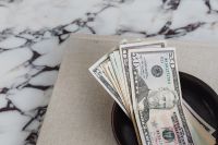 Kaboompics - Dollar bills on a marble table