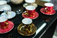 Kaboompics - Red and golden teacups with saucers