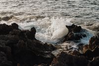 Sea waves crashing on a rocky seashore - summer backgrounds and wallpapers