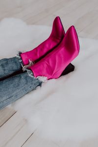 A woman in pink boots and blue jeans