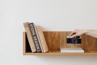 Kaboompics - Old analog camera on wooden shelf