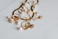 Kaboompics - Gold jewellery on white marble - necklace, bracelets, earrings