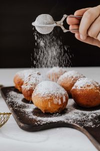 Kaboompics - Homemade Polish doughnuts with cherry filling, covered with powdered sugar. Traditional speciality on Fat Thursday in Poland.
