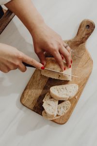 Kaboompics - Slicing bread - ciabatta - bakery