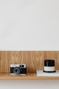 Kaboompics - Old analog camera on wooden shelf - candle