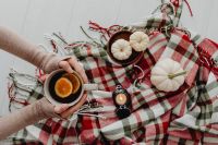 Orange tea - blanket - white pumpkins - candle - flatlay