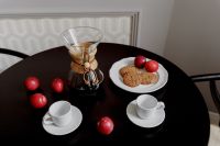 Breakfast served with coffee, cookies and plums