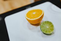 Kaboompics - Orange and a lime on a cutting board