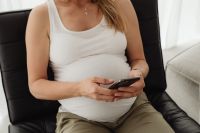 Kaboompics - Pregnant Woman Using Smartphone While Sitting in Armchair