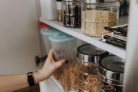 Kaboompics - Containers of cereals in kitchen cupboard
