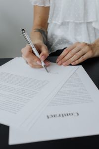 Kaboompics - A businesswoman signs a contract