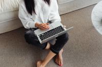 Kaboompics - Adult young Asian woman sits in living room and works on laptop