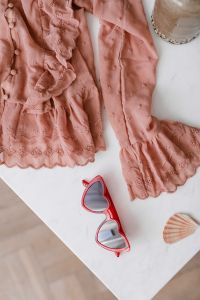 Kaboompics - Blouse in pale pink colour made of thin chiffon with frills & heart shaped sunglasses