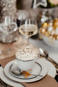 Kaboompics - Coffee with whipped cream in a porcelain cup on a Christmas table