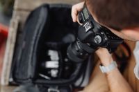 Kaboompics - Photographer holding a DSLR camera