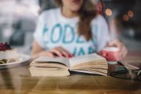 Kaboompics - Woman reading book at coffee shop