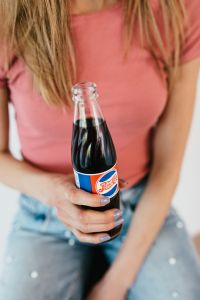 Young woman with Pepsi Cola bottle