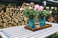 Kaboompics - Pink flowers on a wooden table in a sunny garden