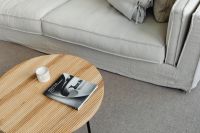 Wooden coffee table - book - candle - linen sofa - pillows - carpet