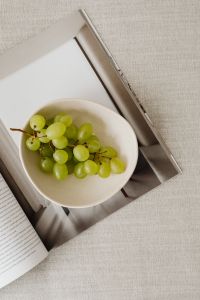 Kaboompics - Magazine and grapes in a bowl on a linen couch