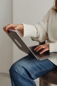 Kaboompics - Woman in white sweater - gold rings - jewelry - jeans - laptop - work