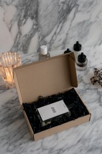 Kaboompics - Skincare Essentials Unboxing: Organic Serum in Eco-Friendly Packaging on a Marble Background