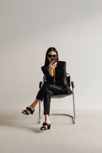 Kaboompics - Dark Classy Aesthetic Fashion - Beautiful Asian Female Entrepreneur in Black Suit - Technology and Devices - iPhone - Laptop - AirPods