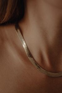 Kaboompics - Details of gold jewelry - beautiful woman wearing a tan silk shirt