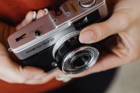 Kaboompics - Old film camera in the hand of a young woman