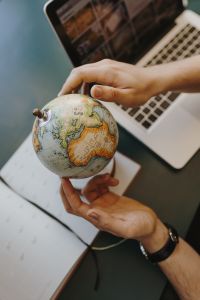 Male Finger Showing A Part Of The World On An Globe