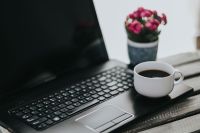 Kaboompics - Little pink flowers with a coffee and a black laptop