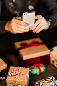 Kaboompics - A handsome man with Christmas presents - using mobile phone