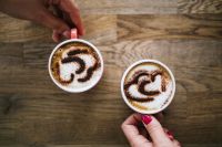 Kaboompics - A cups of coffee with heart latte art on top