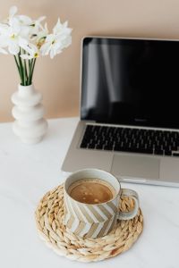 Kaboompics - Laptop - white flowers & cup of coffee on marble table