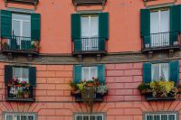 The facade of an orange tenement house in Naples