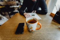 Kaboompics - Mug with hot tea & mobile phone on the table