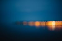 Kaboompics - Blurred city lights reflected in the water at night
