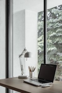 Kaboompics - Home office desk with laptop by a large window