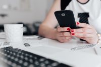 Kaboompics - Businesswoman uses her mobile phone at her desk