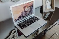Kaboompics - Silver Apple MacBook Pro on a shiny table