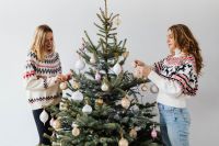 Women Decorate Christmas Trees