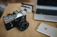 Old Zenit camera with iPhone and a laptop
