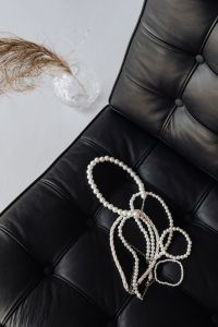 Pearl necklaces - jewelry - black leather chair - Ludwig Mies van der Rohe - Lounge chair - Barcelona chair