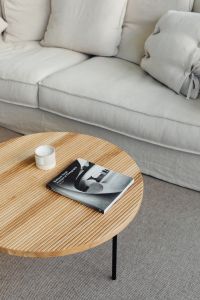 Kaboompics - Wooden coffee table - book - candle - linen sofa - pillows - carpet