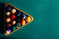 Kaboompics - Billiard balls on green table with billiard cue