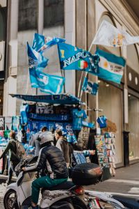 Kaboompics - Stall with gadgets for fans of the football club SSC Napoli, blue flags and T-shirts