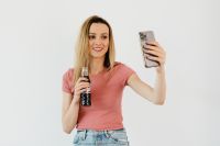 Young woman taking a salfie with iPhone 11 Pro