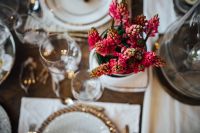 Kaboompics - Table decorations with golden motifs and red flowers