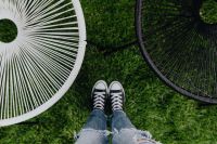 Kaboompics - Woman, jeans, sneakers, garden chairs, green grass